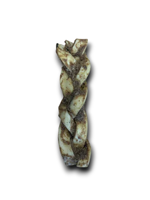 Braided rawhide dog chew treat with specks of seasoning on black background
